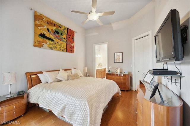 bedroom featuring a closet, dark hardwood / wood-style floors, ceiling fan, and ensuite bathroom