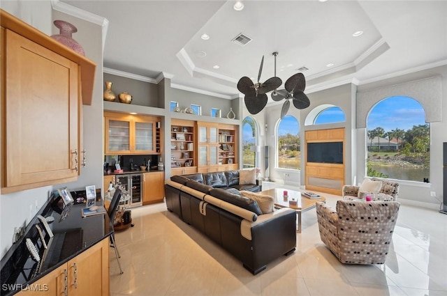 tiled living room with wine cooler, crown molding, a raised ceiling, and ceiling fan