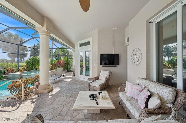 sunroom / solarium featuring decorative columns and ceiling fan