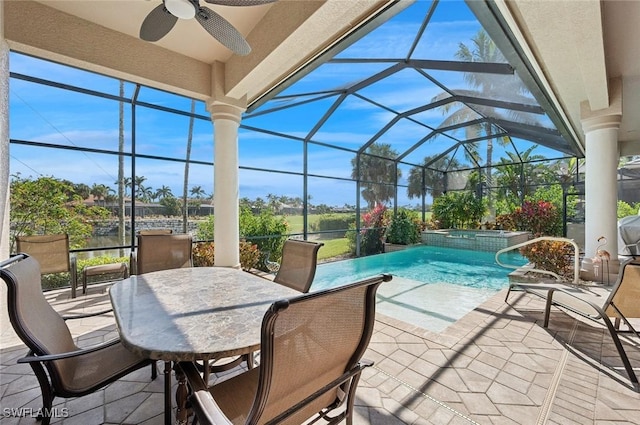 view of patio featuring a swimming pool with hot tub, a lanai, and ceiling fan