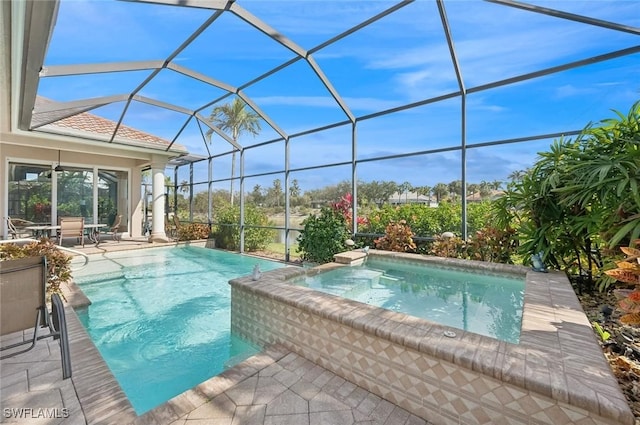 view of swimming pool with a lanai and a patio area