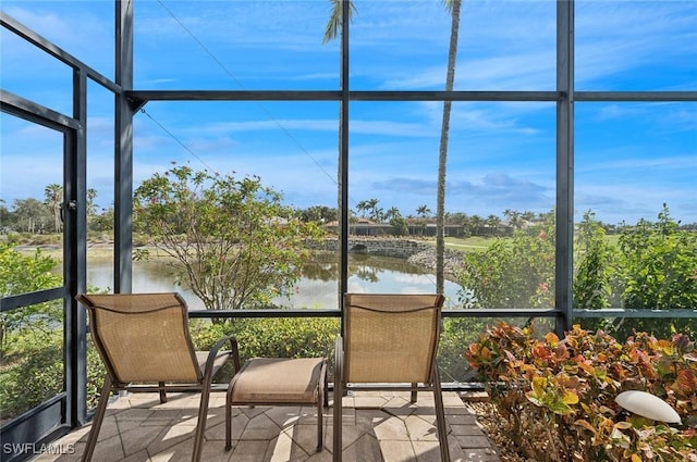 unfurnished sunroom with a water view