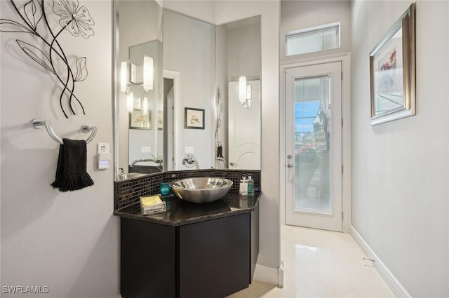 bathroom featuring tasteful backsplash, vanity, and tile patterned flooring