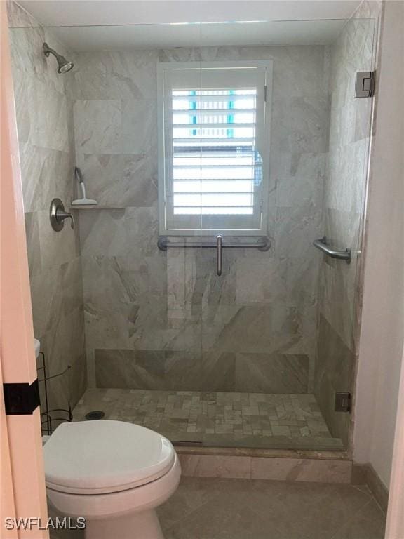 bathroom with walk in shower, tile patterned floors, and toilet