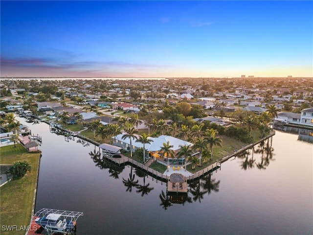 aerial view at dusk with a water view