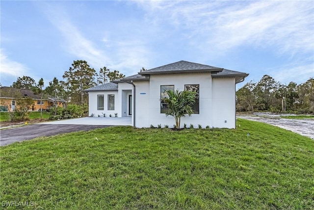 view of front of property with a patio and a front yard