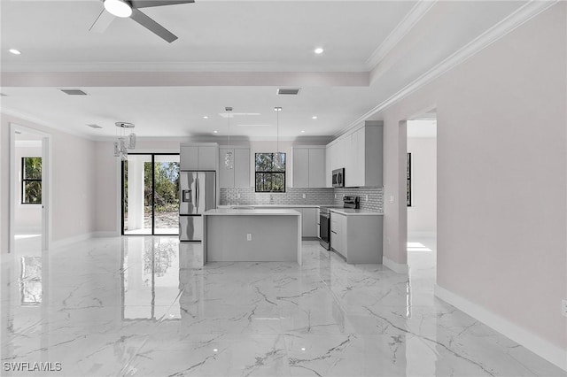 kitchen featuring gray cabinetry, decorative backsplash, hanging light fixtures, a center island, and stainless steel appliances