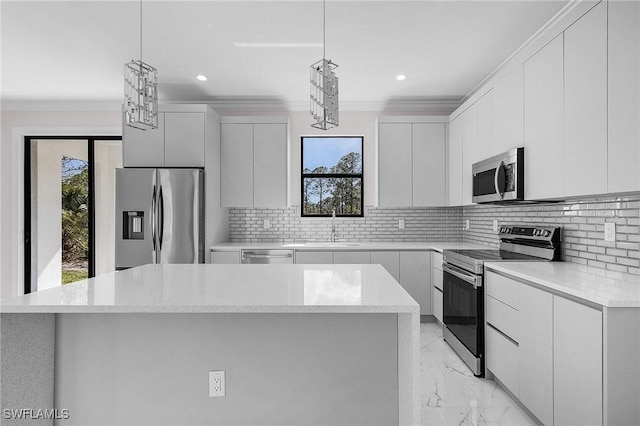 kitchen with white cabinetry, decorative light fixtures, a center island, and appliances with stainless steel finishes