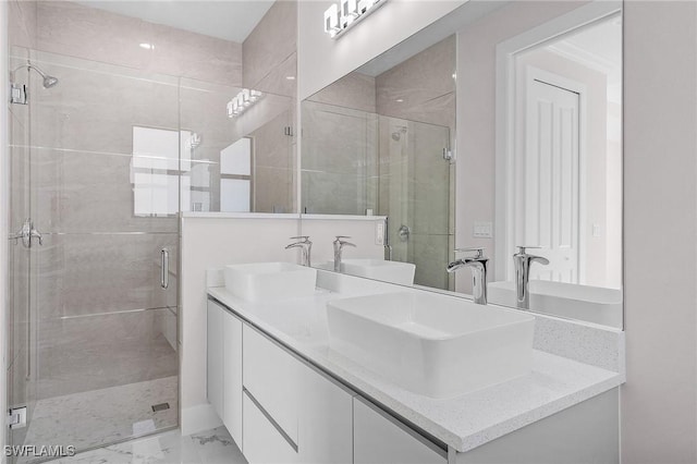 bathroom featuring vanity and a shower with shower door