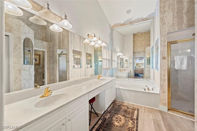 full bath with double vanity, wood finished floors, a stall shower, and a sink