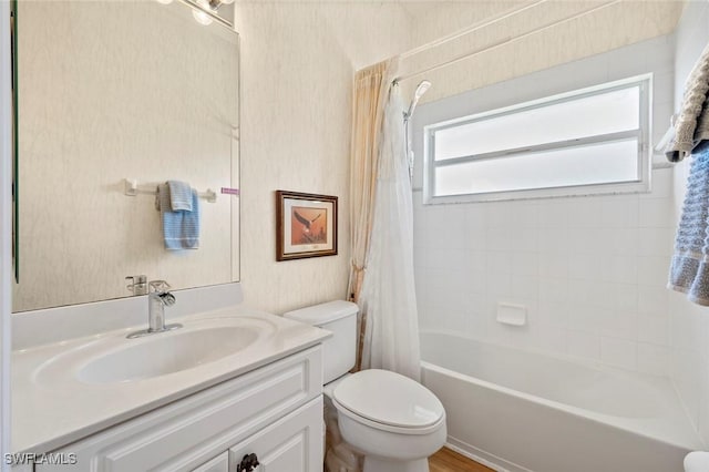 full bath with shower / tub combo, vanity, and toilet