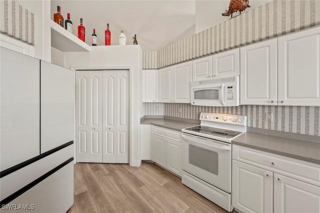 kitchen featuring white cabinetry, white appliances, and light hardwood / wood-style flooring