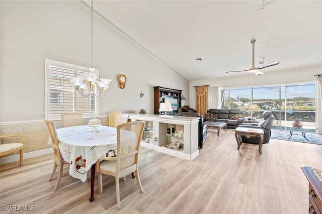 dining space featuring hardwood / wood-style flooring, high vaulted ceiling, and a chandelier