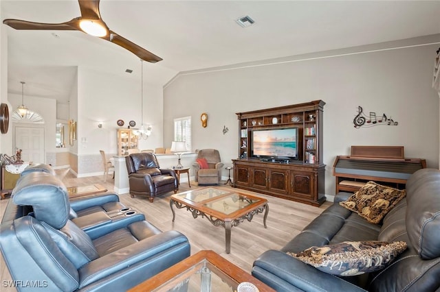 living room with lofted ceiling, light hardwood / wood-style flooring, and ceiling fan