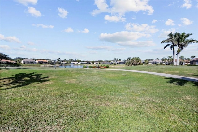 view of community featuring a lawn and a water view