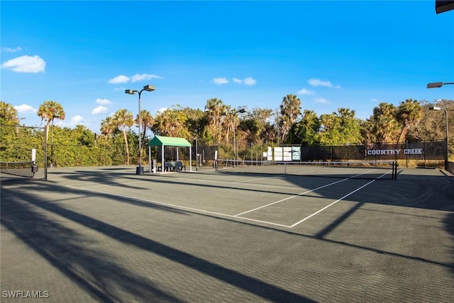 view of sport court featuring fence