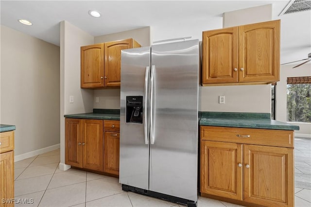 kitchen with light tile patterned floors, ceiling fan, and stainless steel fridge with ice dispenser