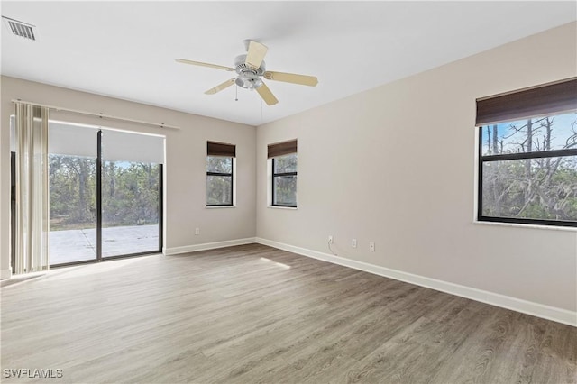 empty room featuring ceiling fan and hardwood / wood-style floors