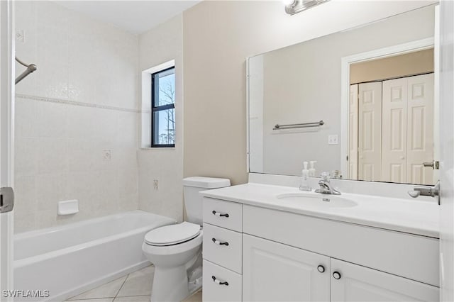 full bathroom with tiled shower / bath combo, vanity, tile patterned floors, and toilet