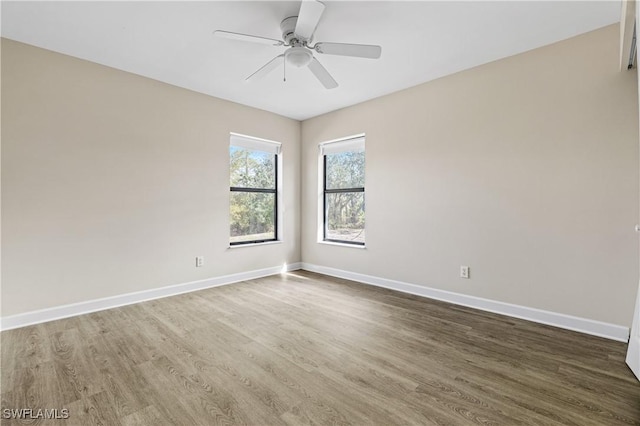 spare room featuring dark hardwood / wood-style flooring and ceiling fan