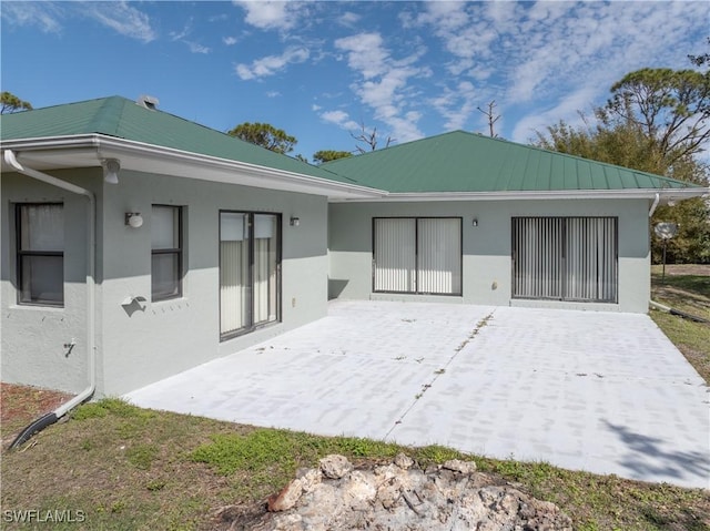 back of house with a patio