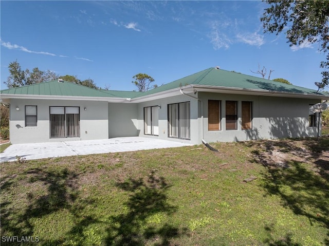 rear view of property featuring a yard and a patio area