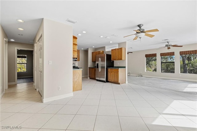 kitchen featuring stainless steel refrigerator with ice dispenser and light tile patterned floors