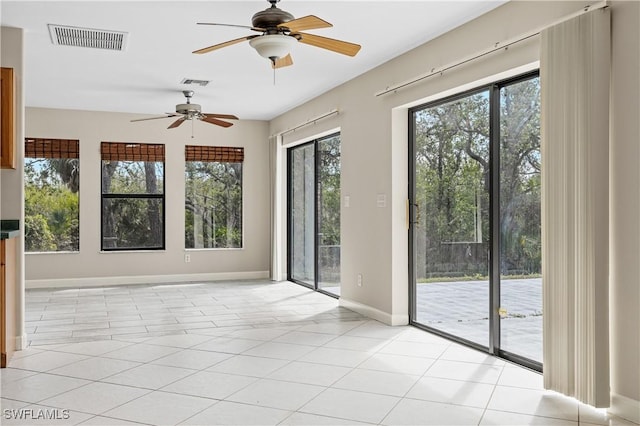 spare room featuring light tile patterned floors and ceiling fan