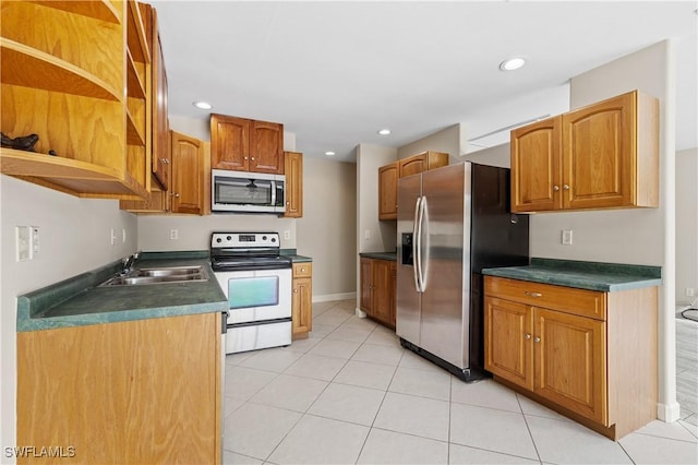 kitchen featuring appliances with stainless steel finishes, sink, and light tile patterned floors