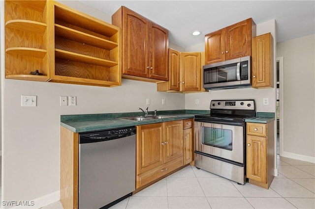 kitchen with stainless steel appliances, sink, and light tile patterned floors