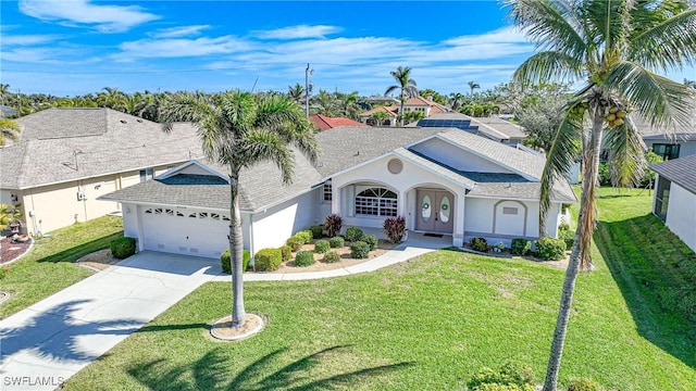 view of front of house with a garage and a front lawn