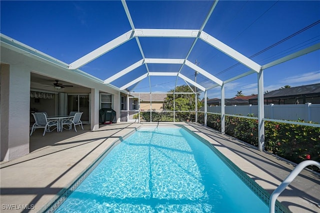 view of pool featuring a lanai, area for grilling, ceiling fan, and a patio area