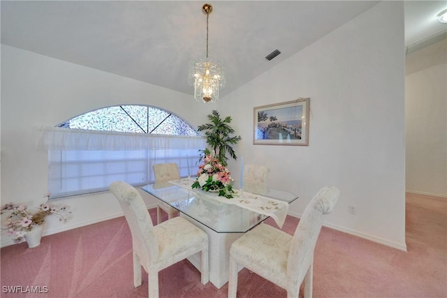 dining area featuring vaulted ceiling, light colored carpet, and a chandelier