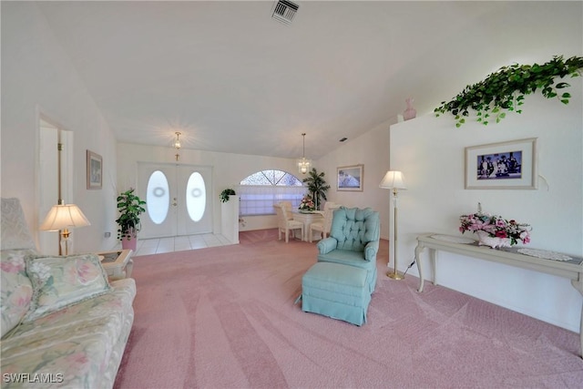 living room with french doors, vaulted ceiling, and light carpet