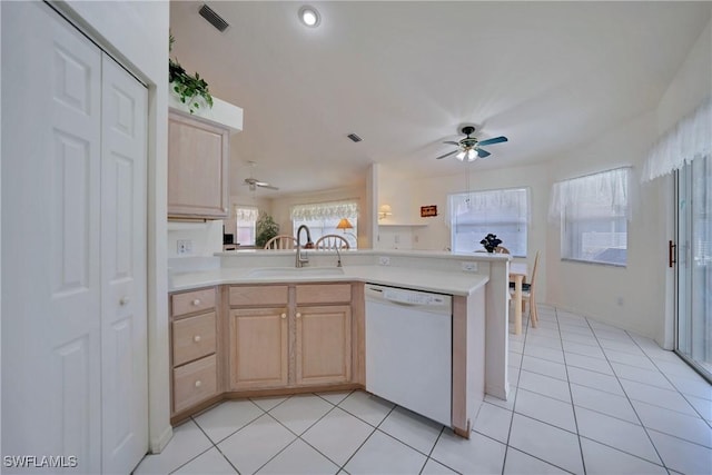 kitchen featuring sink, light brown cabinetry, white dishwasher, and kitchen peninsula