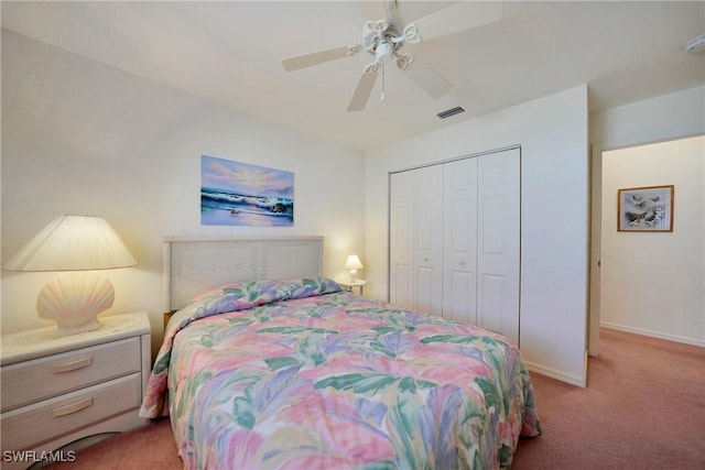 bedroom featuring ceiling fan, light colored carpet, and a closet