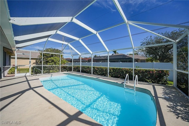 view of swimming pool with a lanai and a patio