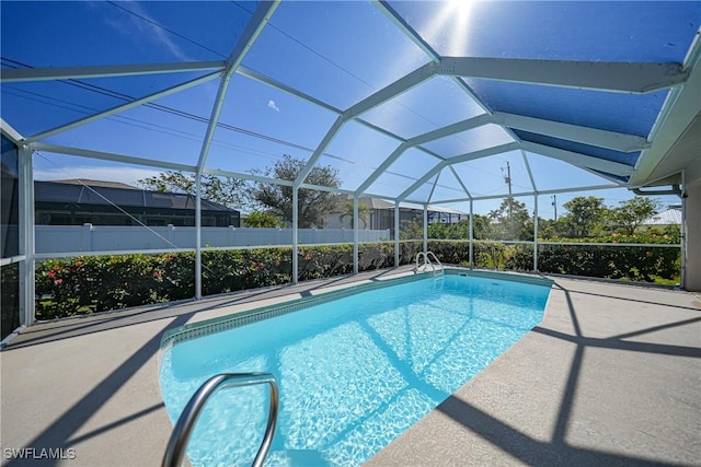 view of swimming pool with glass enclosure