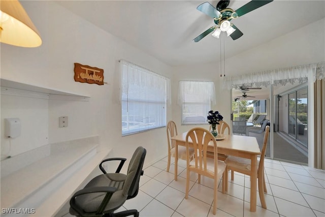 dining space featuring vaulted ceiling, ceiling fan, and light tile patterned flooring