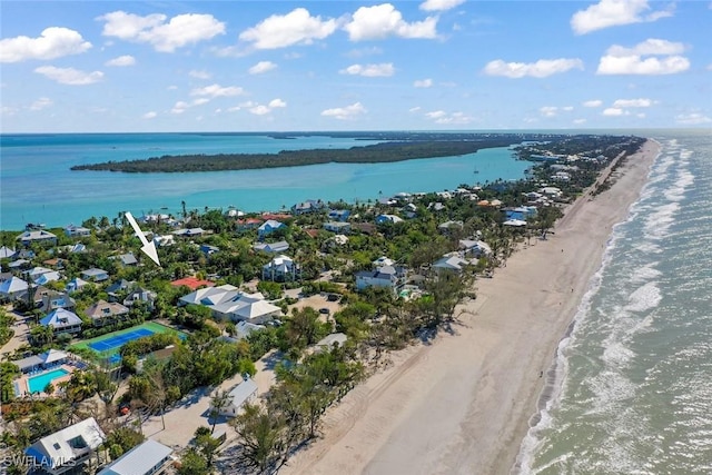 birds eye view of property with a water view and a view of the beach