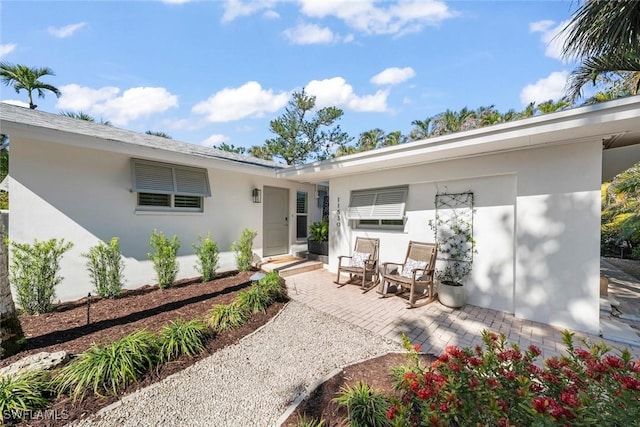 back of property with a patio