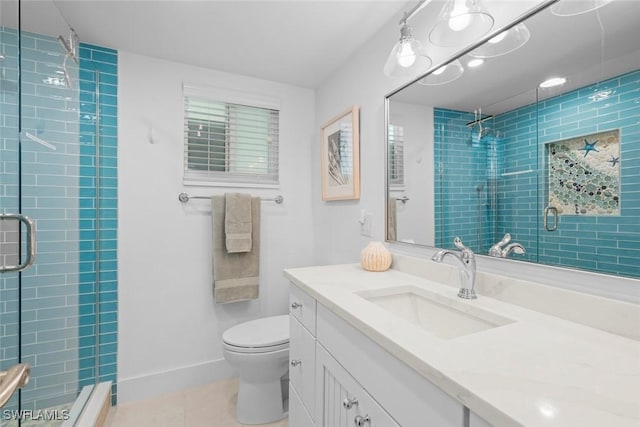 bathroom with vanity, toilet, a shower with shower door, and tile patterned flooring