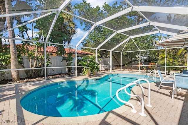 view of pool featuring a patio area and glass enclosure