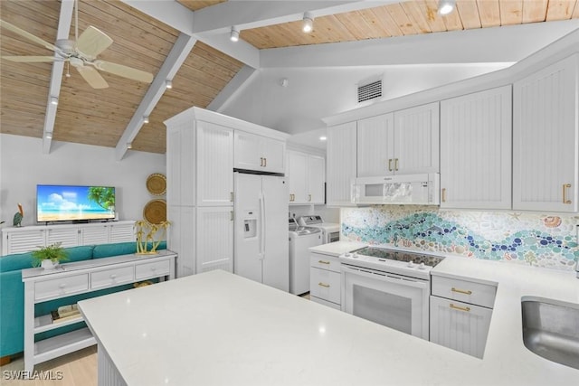 kitchen featuring vaulted ceiling with beams, backsplash, white appliances, washer and clothes dryer, and white cabinets