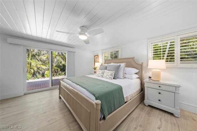 bedroom with multiple windows, access to outside, ceiling fan, and light hardwood / wood-style flooring