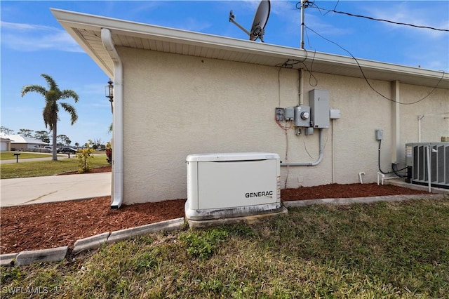 view of property exterior with a yard and central AC