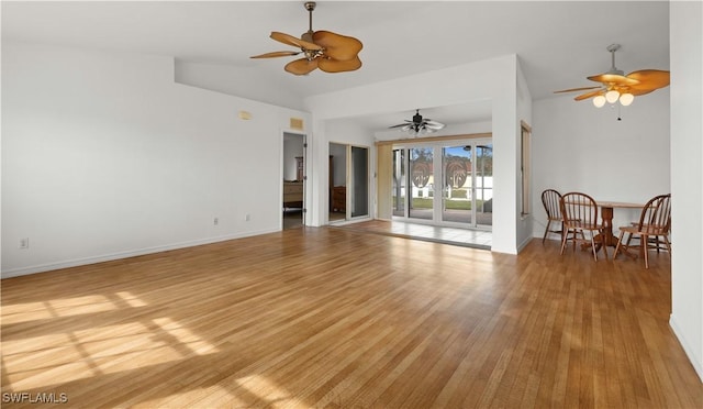 living room featuring lofted ceiling, ceiling fan, and light wood-type flooring