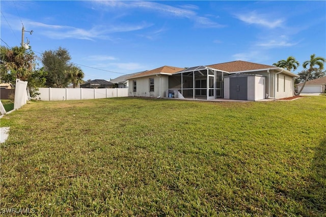 back of house with a yard and a storage unit