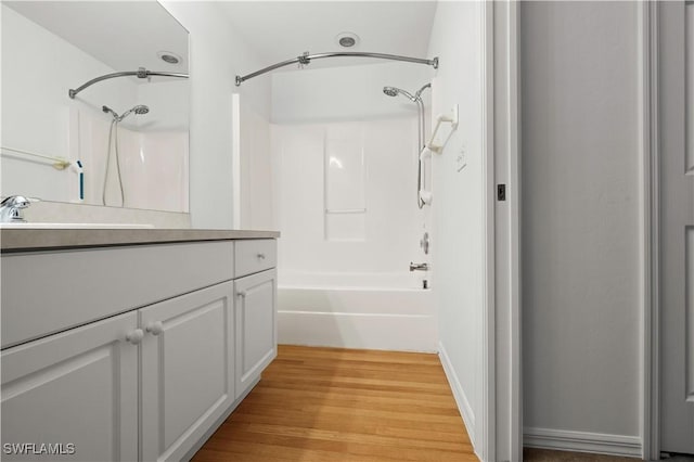 bathroom featuring vanity, shower / bath combination, and hardwood / wood-style floors