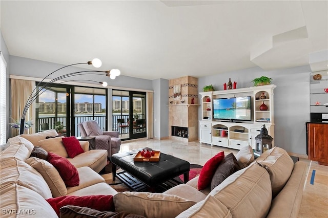 living room with an inviting chandelier and a fireplace